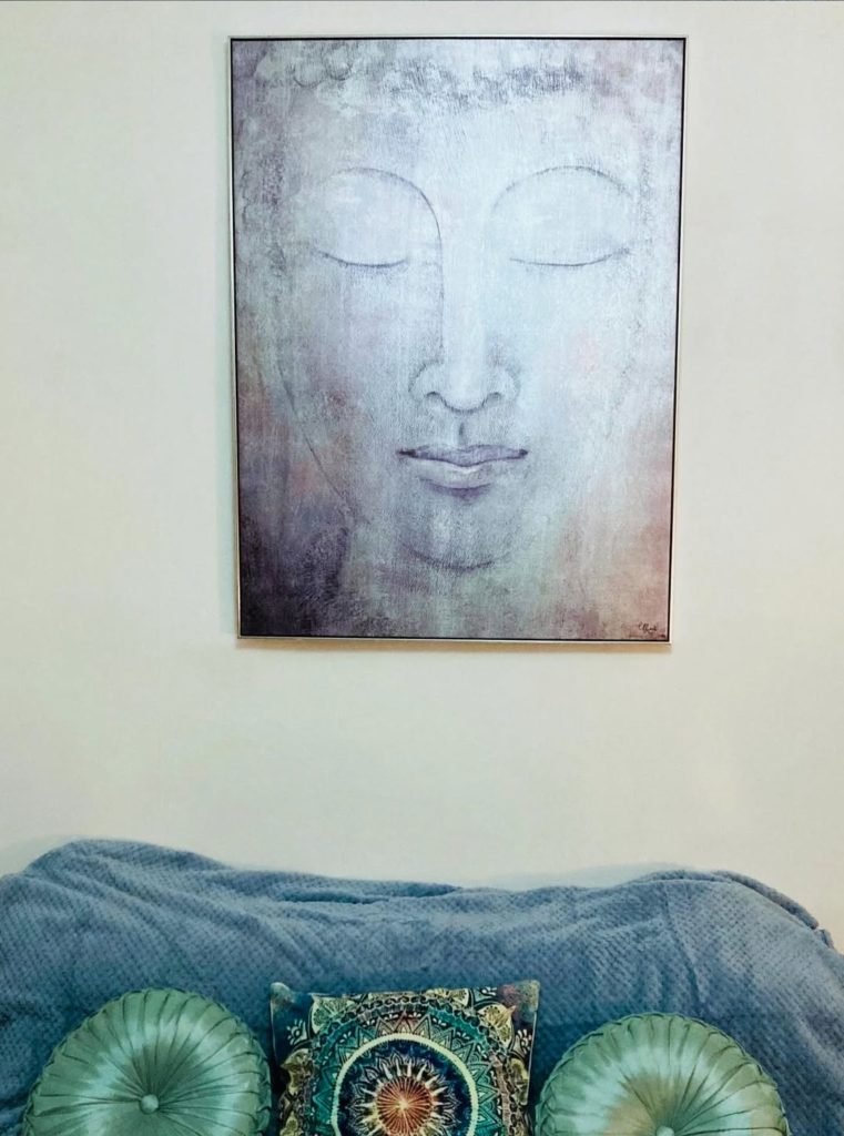 Calming artwork and teal cushions in the Soul Peace Holistic Healing room