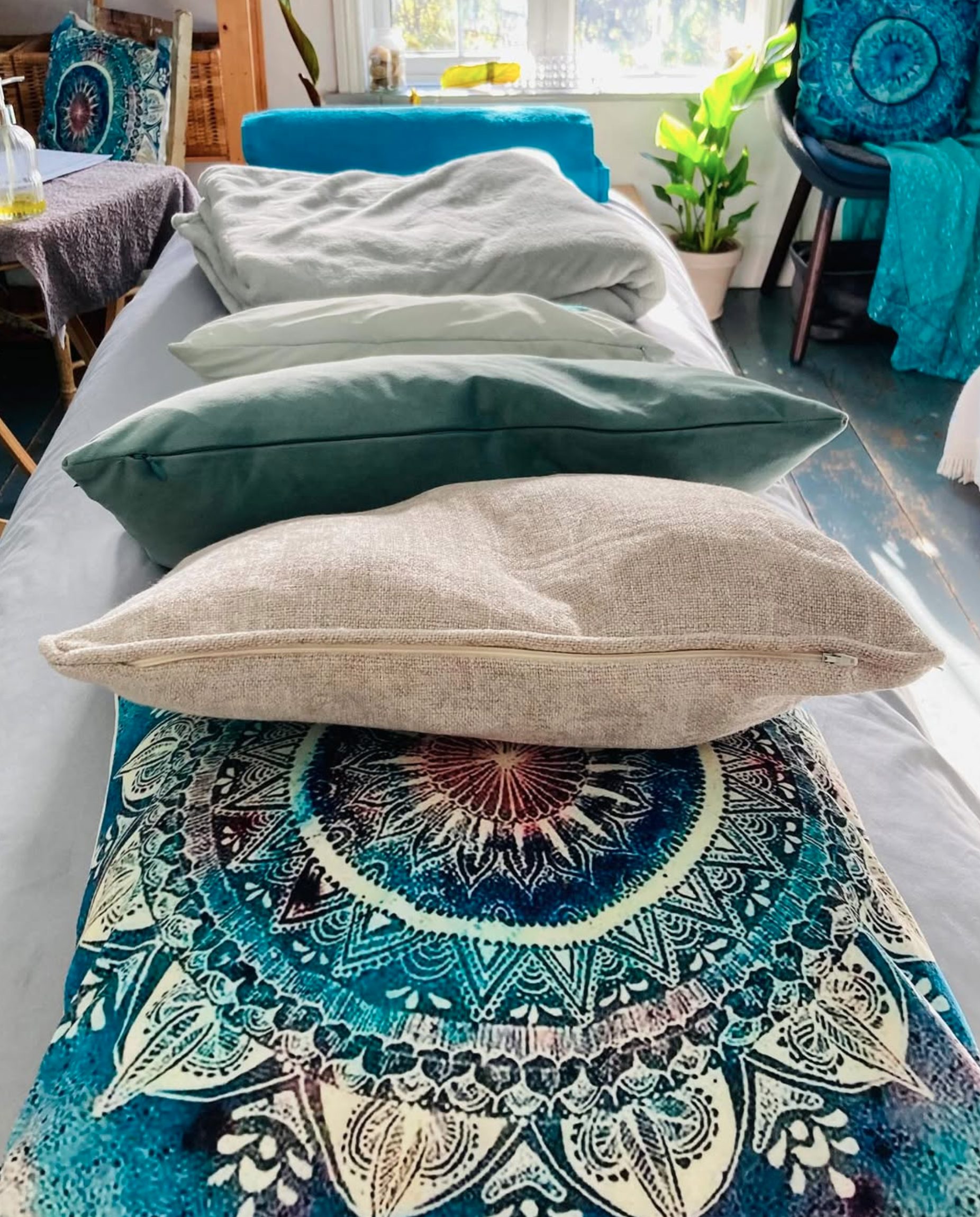 Prepared treatment bed with cushions in the Soul Peace Holistic Healing room