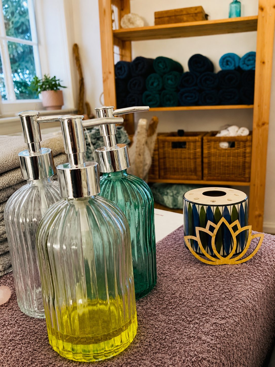 Treatment oils, towels and lotus detail in the Soul Peace treatment room